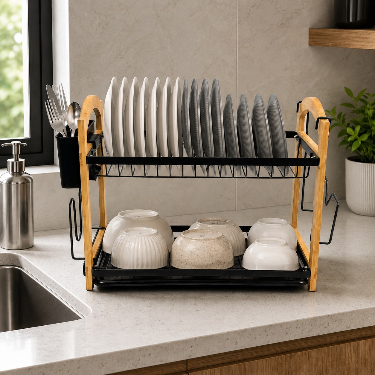 2 Tier Kitchen Dish Drying Rack on a kitchen countertop, holding upright white and gray plates on the top shelf and white bowls on the bottom shelf.