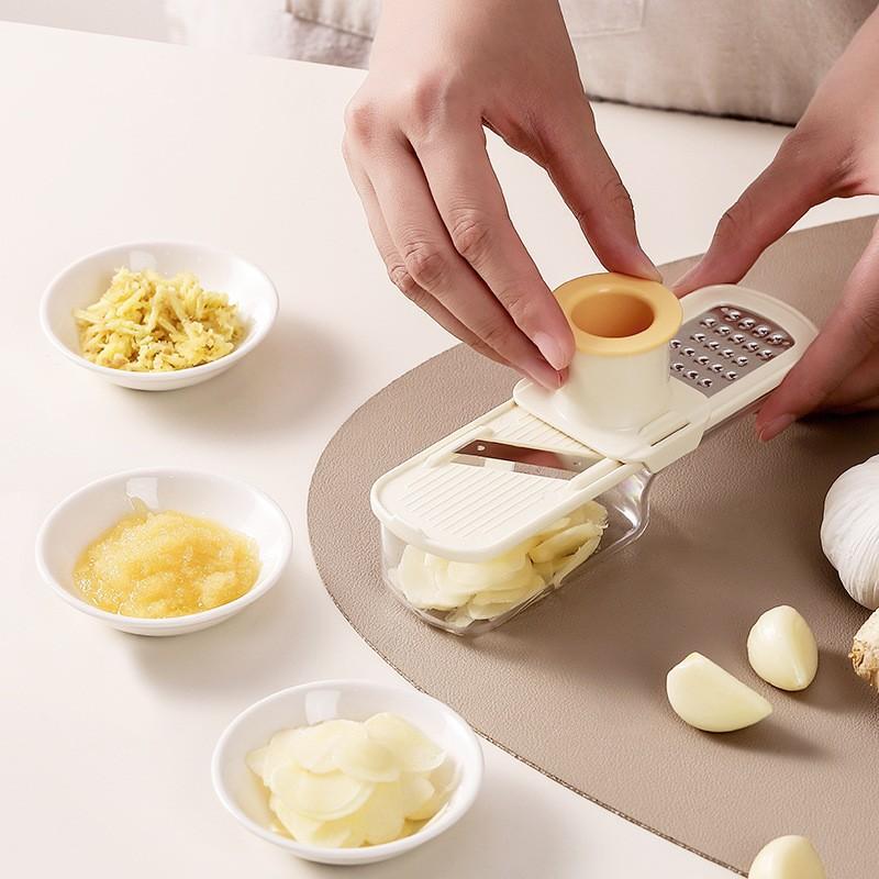 A Person is Slicing Ginger Using 3-in-1 Triple Mini Slicer.