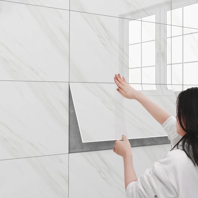 A Women is Sticking 3D Imitation Marble Pattern Wall Sticker On Wall.