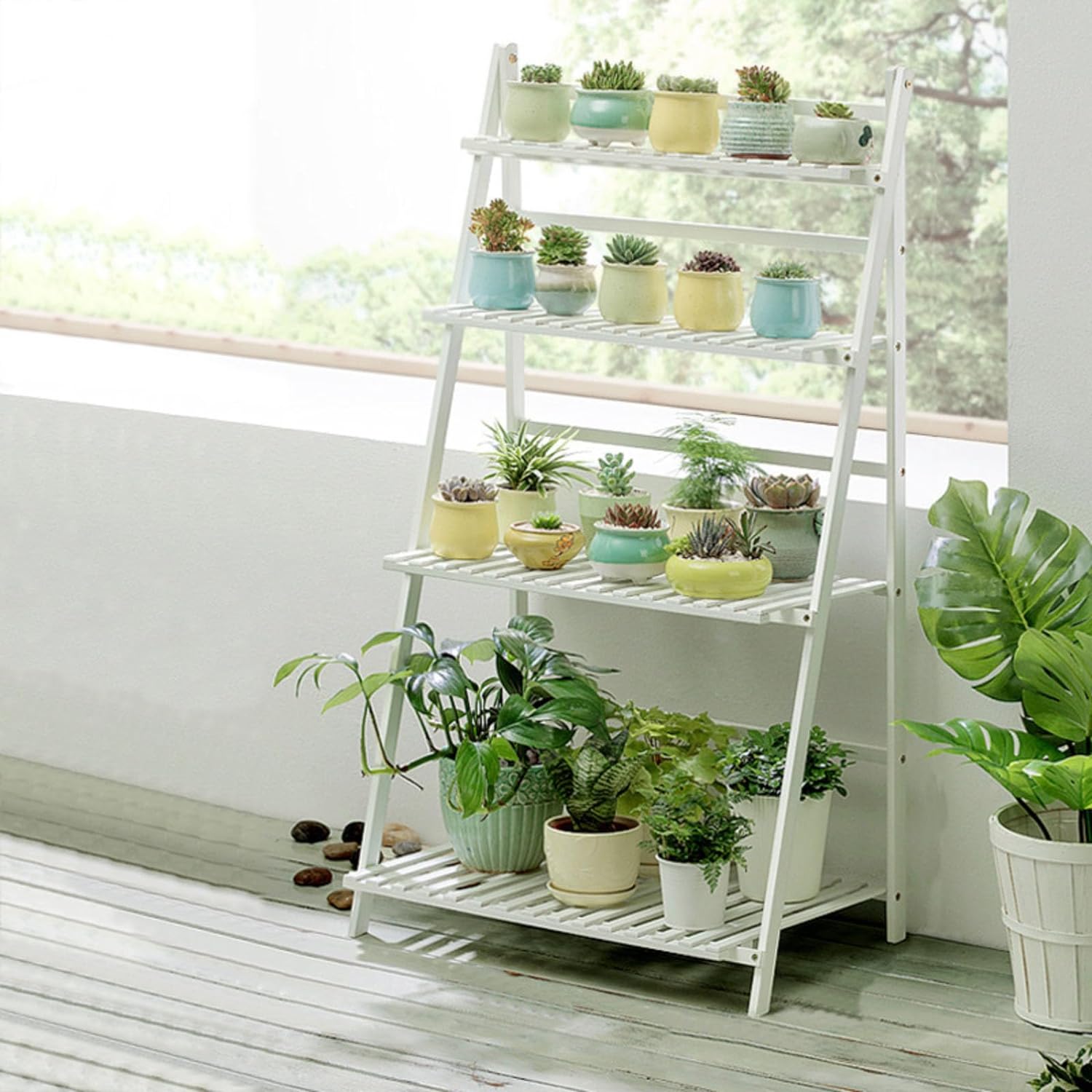 The 4-Layer Foldable Indoor Wooden Plant Stand is elegantly arranged with various plants