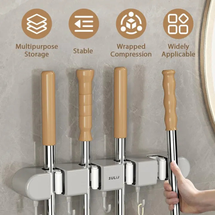 A person Hanging mop in Wall-Mounted Mop Holder & Broom Hanger