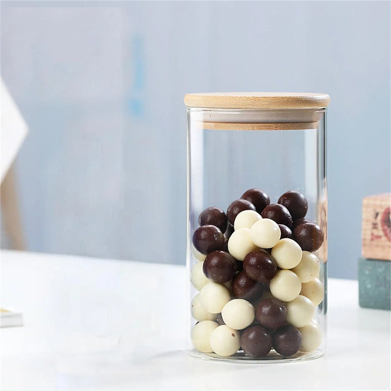 A Glass Storage Jar is Stored with Candies.