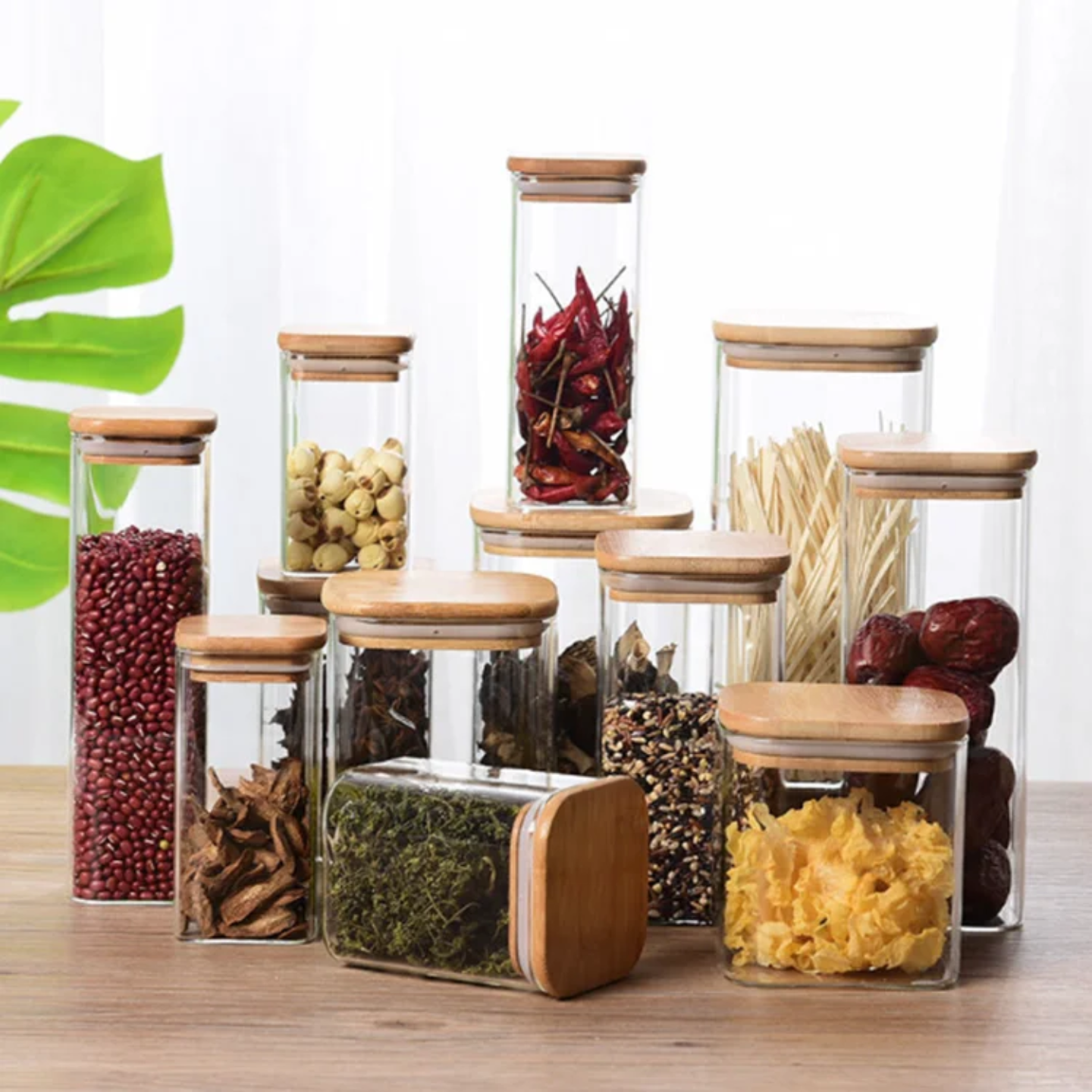 A Set Of Glass Storage Jars are Filled with Spices.