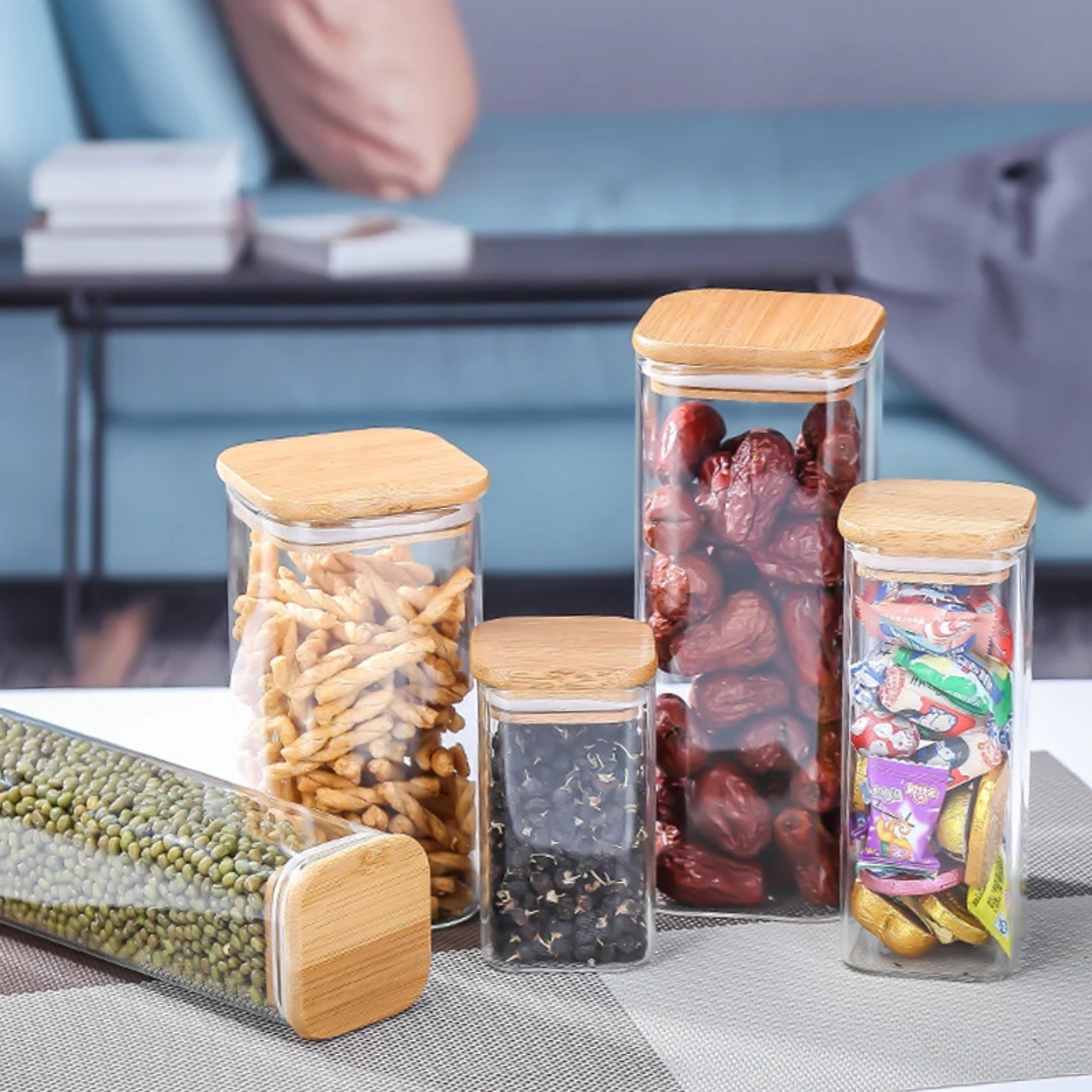 A Set Of Glass Storage Jars are Filled with Snacks.