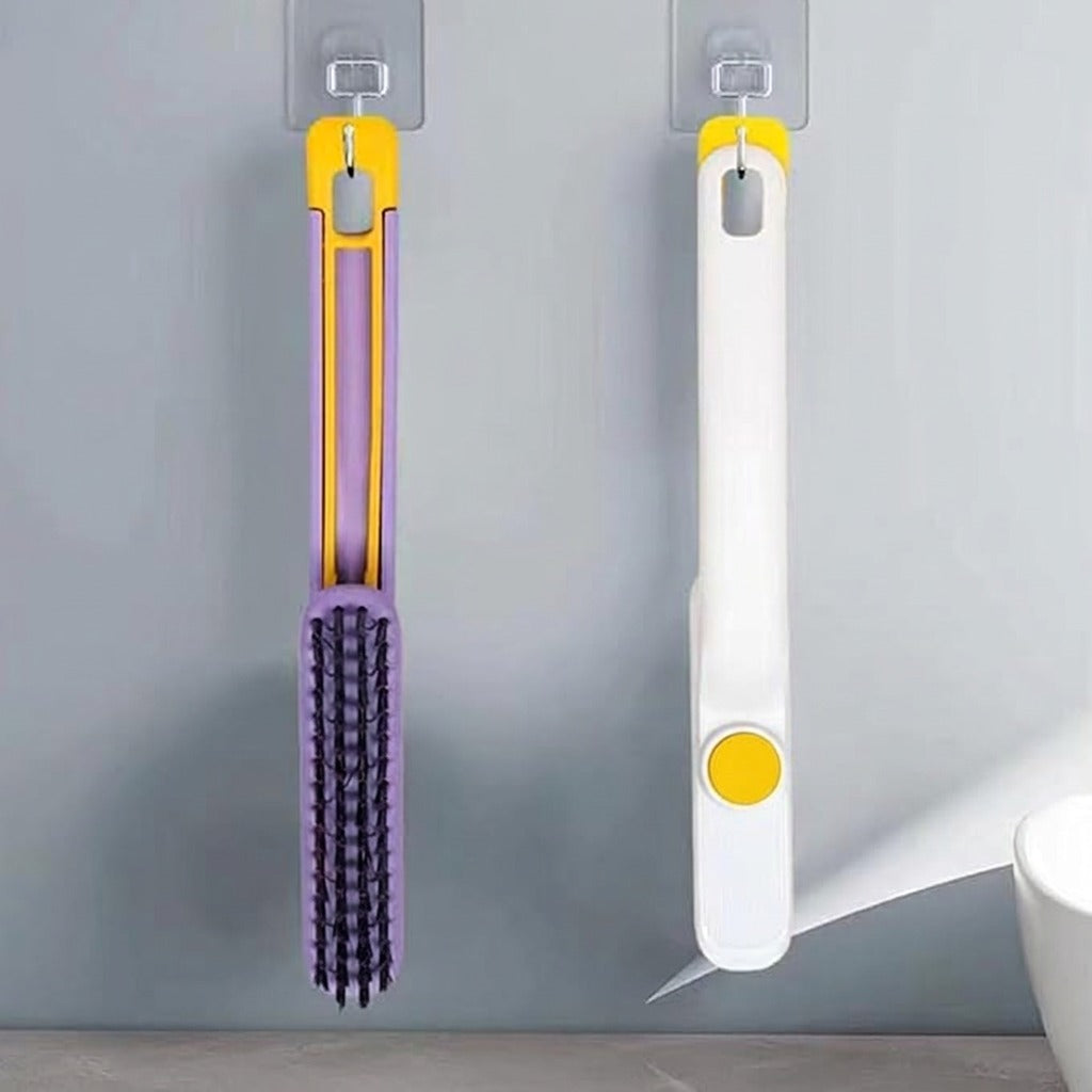 A foldable cleaning brush with a rotating head, shown mounted on a wall hook.