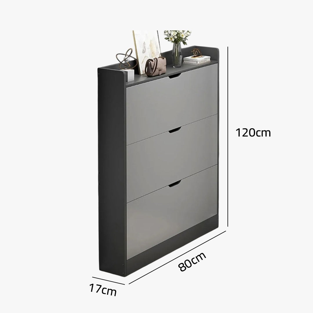 A slim shoe cabinet with flip drawers that neatly stores shoes while saving space, with a top surface for décor or essentials.