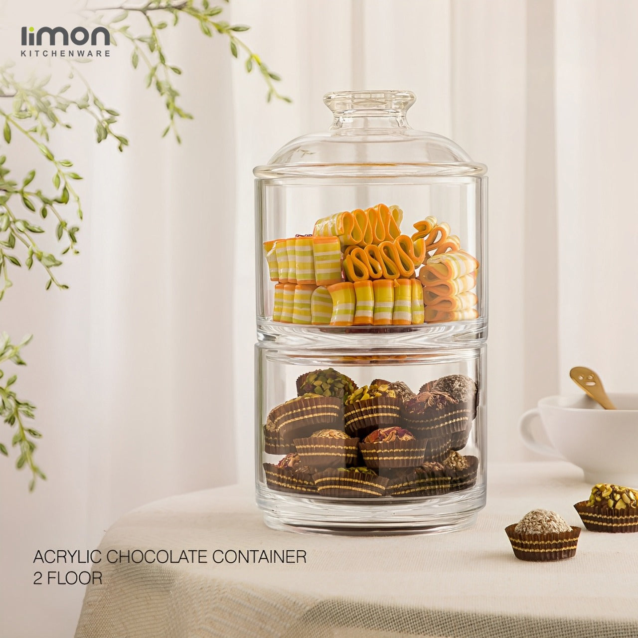 An Acrylic Chocolate Container With Snacks.