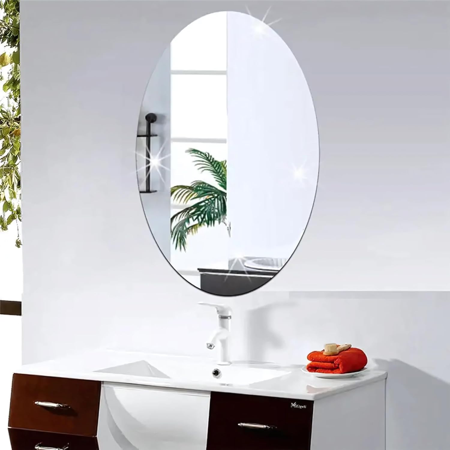 An Adhesive Mirror Wall Sticker is Fixed on a Wall Near Wash Basin.