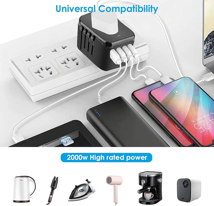 All-in-One Universal Travel Adapter with Multiple USB Ports placed on the table next to a mobile phone, power bank, and tablet, all of which are plugged into it