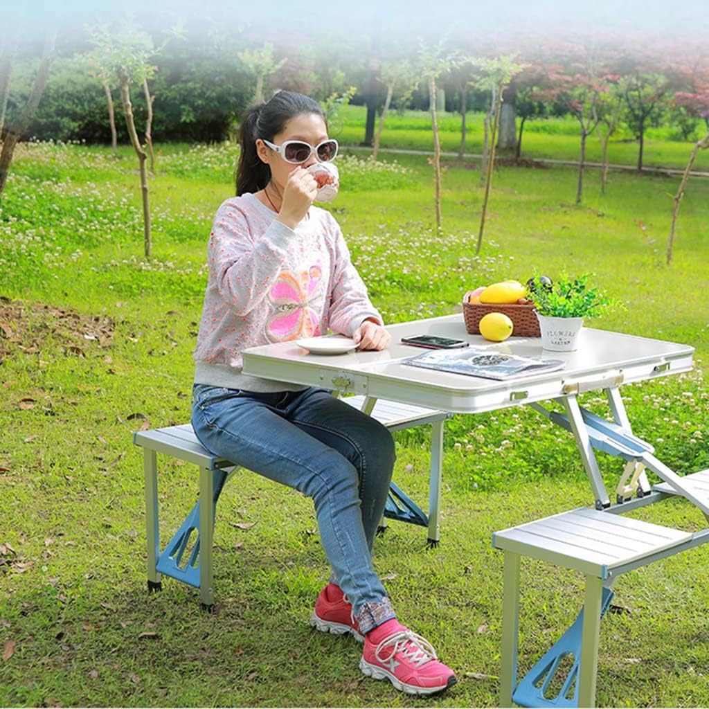 A Woman is Sitting On a Aluminum Picnic Table and Enjoying Her Camping.