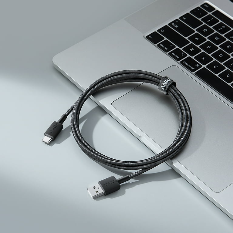 The Anker 322 USB-A to USB-C Braided Cable, measuring 1.8 meters, is placed on the laptop