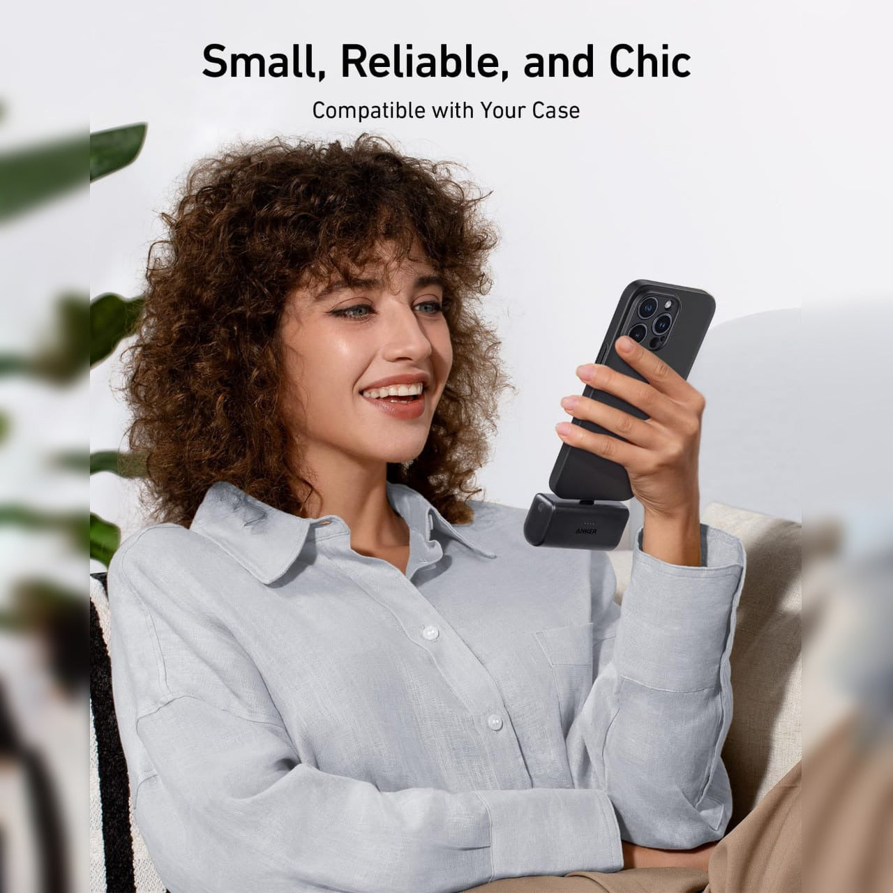 A Woman is Holding Mobile Phone Which is Connected to Anker Nano Power Bank 5,000mAh.