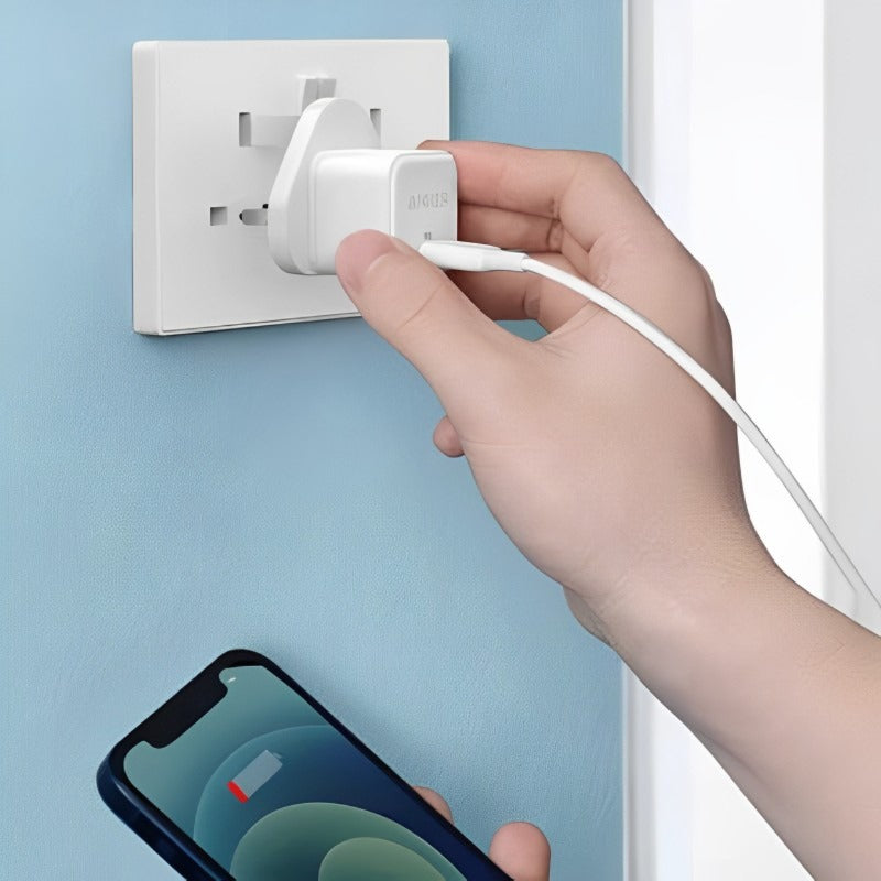 Someone trying to plug in the Anker PowerPort III 20W Cube USB-C Port High-Speed Mini Charger