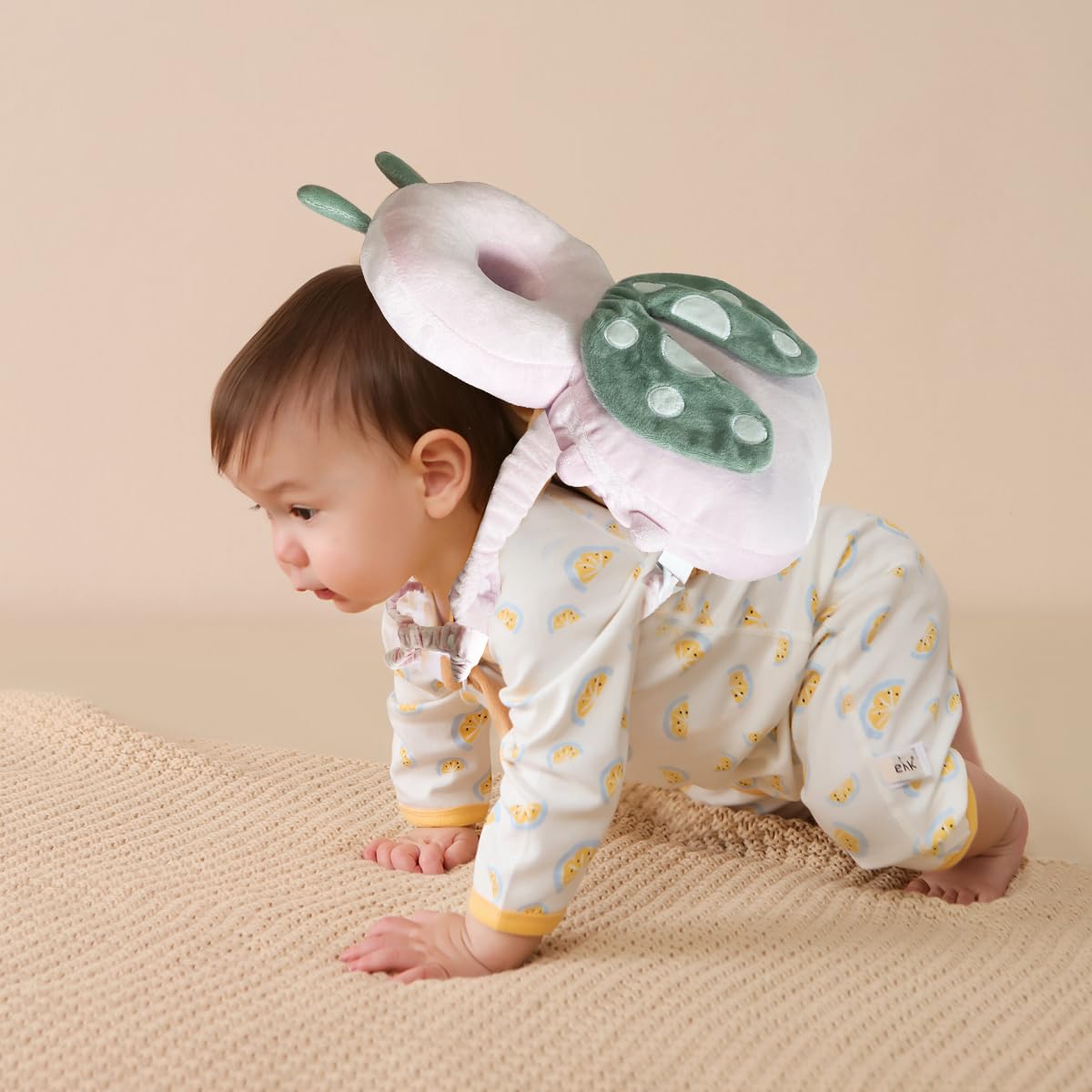 A Baby is Wearing Baby Head Protector Pillow.