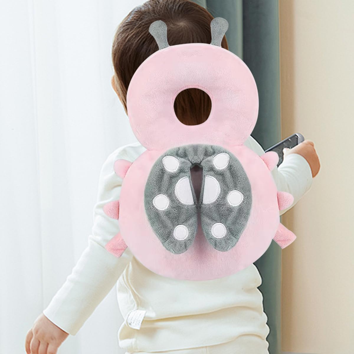 A Baby is Wearing Baby Head Protector Pillow.