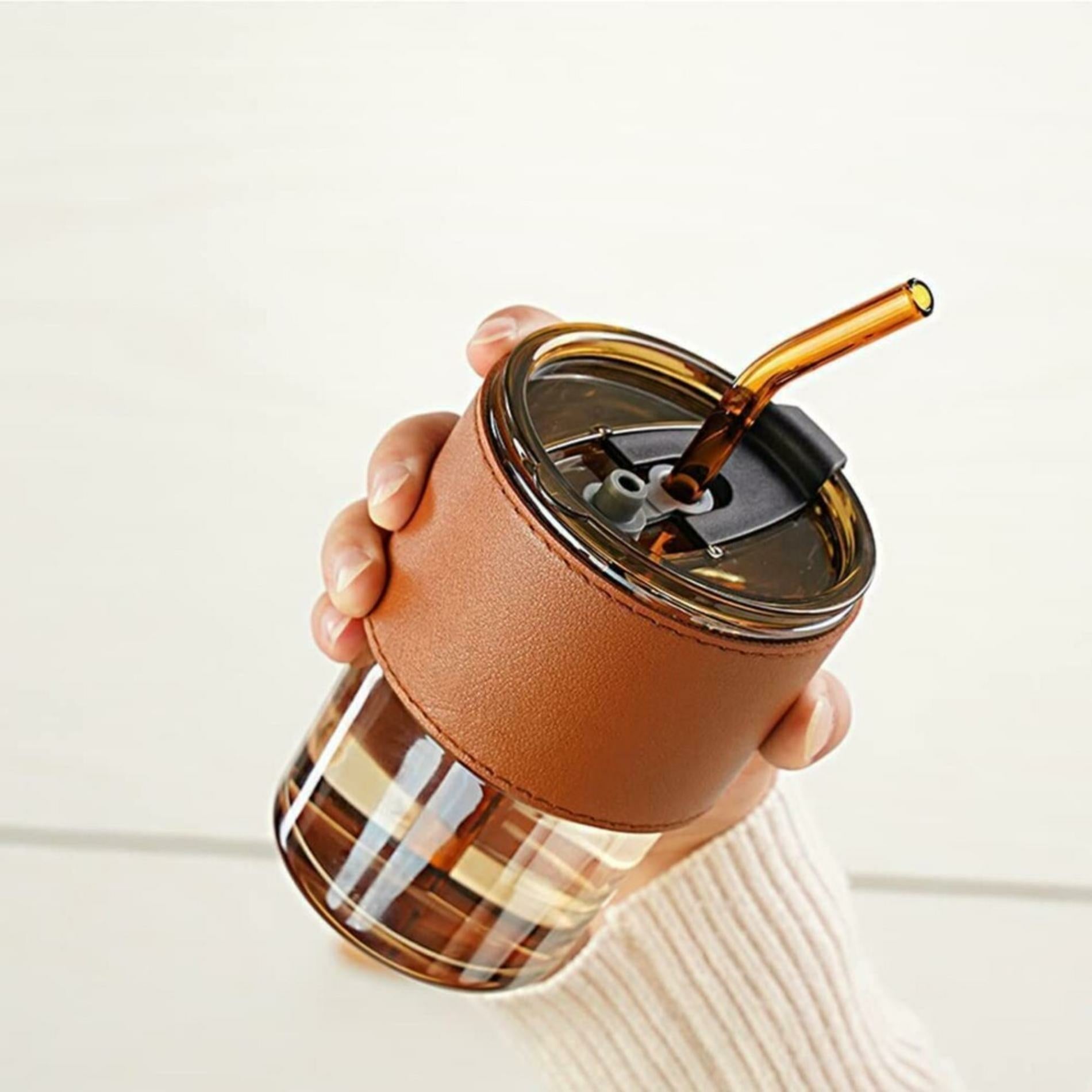 Someone is Holding Bamboo Glass Cup.