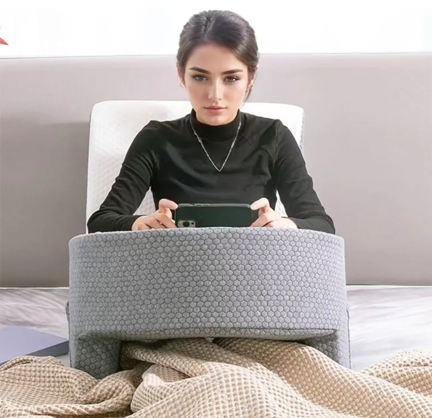 A Woman is Using Mobile Phone in the Bed with the Support Of Bed Reading Pillow.