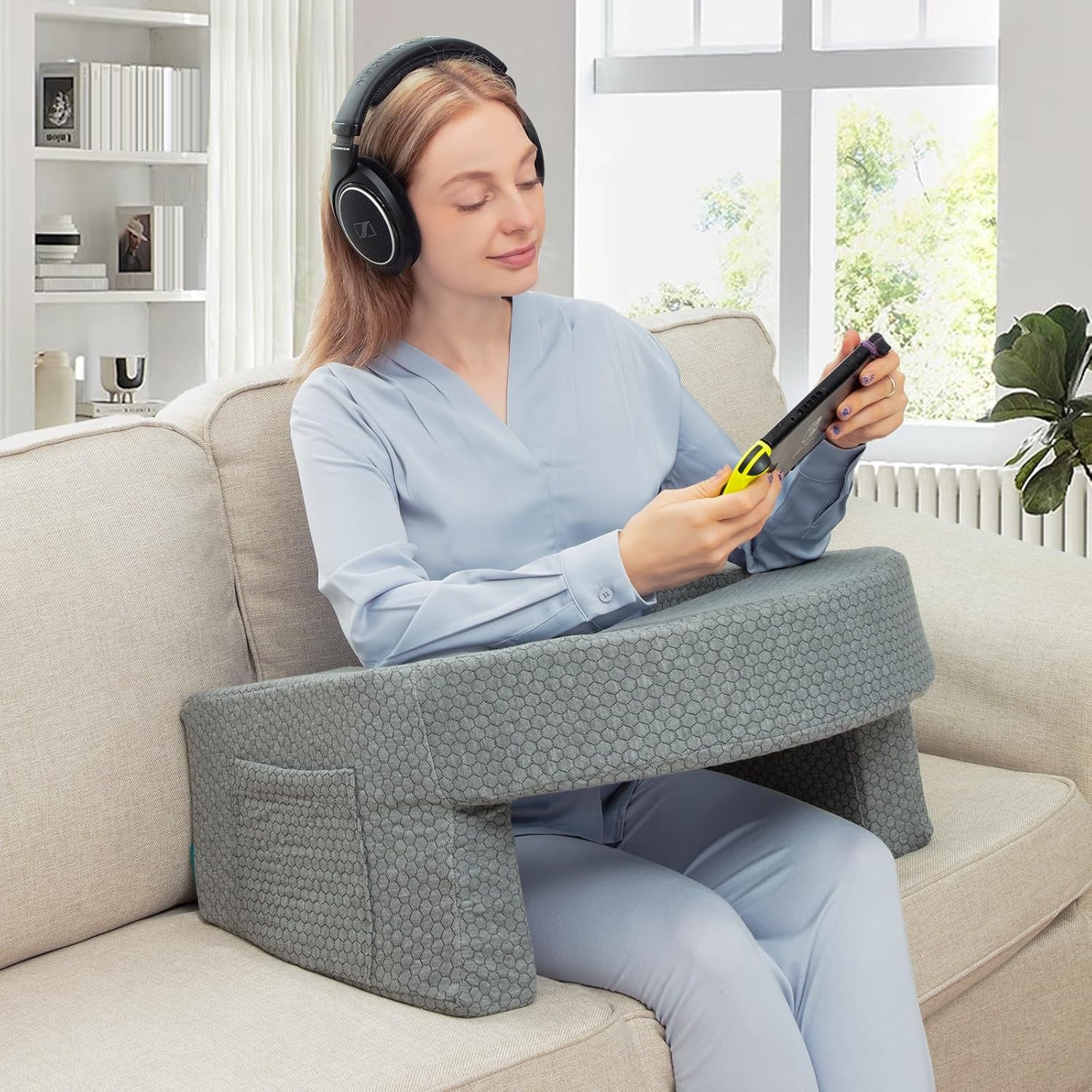 A Woman is Using Phone with the Support Of Bed Reading Pillow.