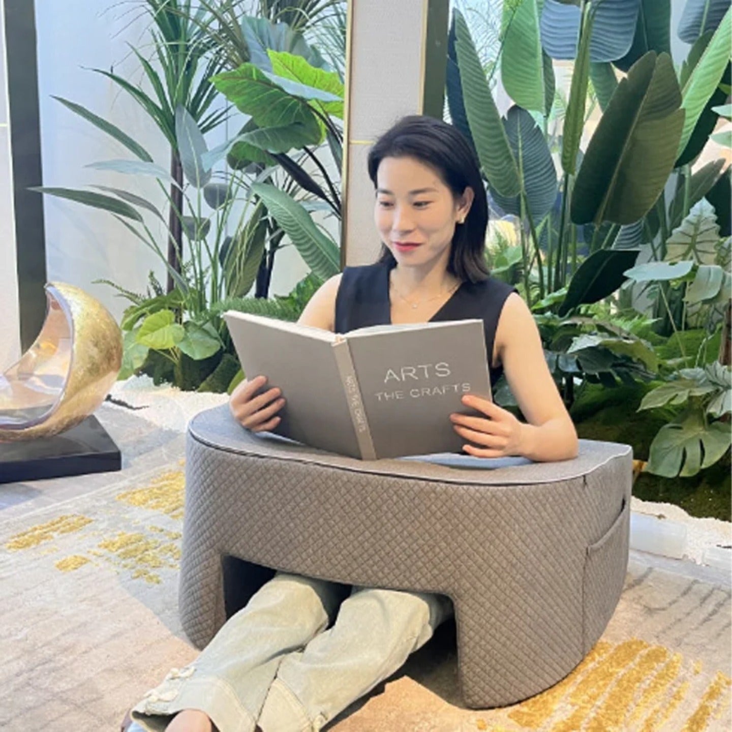 A Woman is Reading Book with the Support Of Bed Reading Pillow.