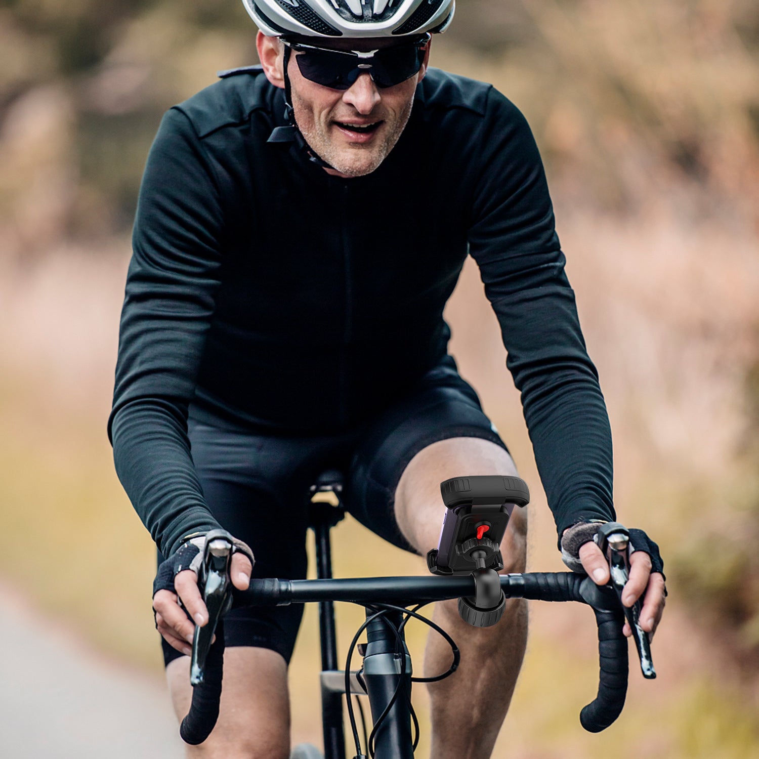 A Person is Attached Bike Mobile Phone Holder on his Cycle and Cycling.