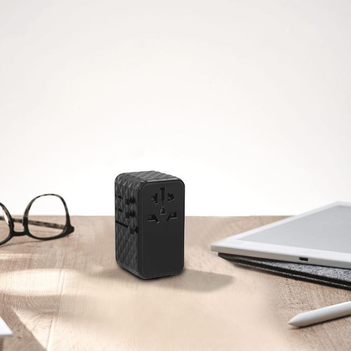 Powerology 4-Port Universal GaN Super Charger placed on the table next to spectacles