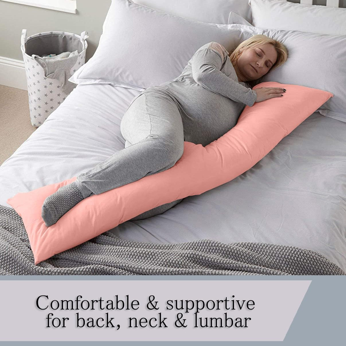 A Pregnant Woman is Sleeping with the Aid Of Body Pillow.