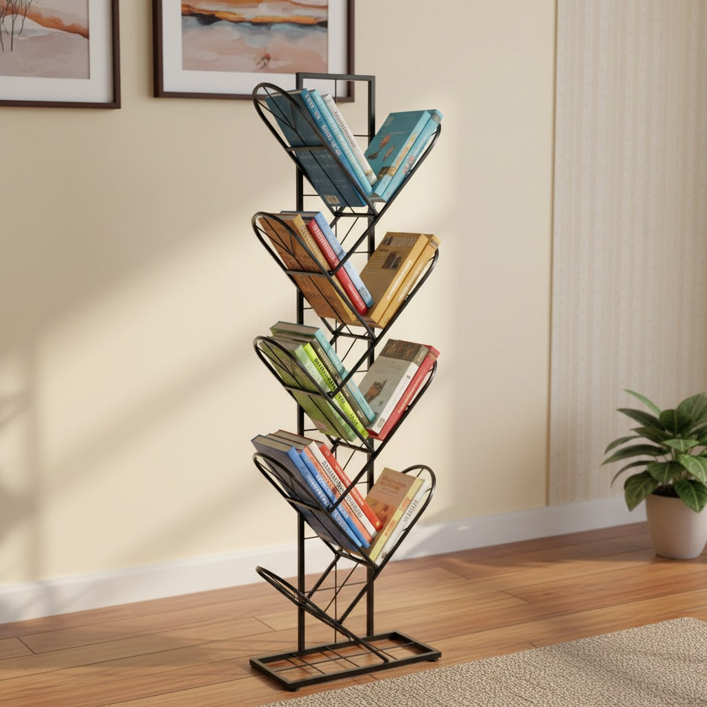 Bookshelf with books on a wooden floor in a room with a plant and framed pictures.