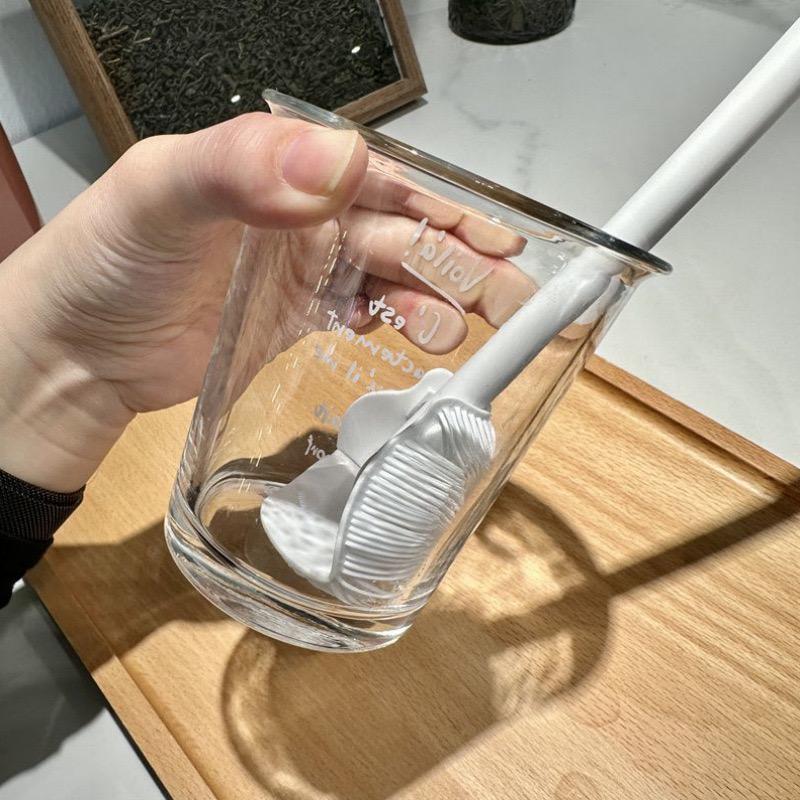 A Person is Cleaning Glass Cup Using Bottle Cup Cleaning Brush with Long Handle.