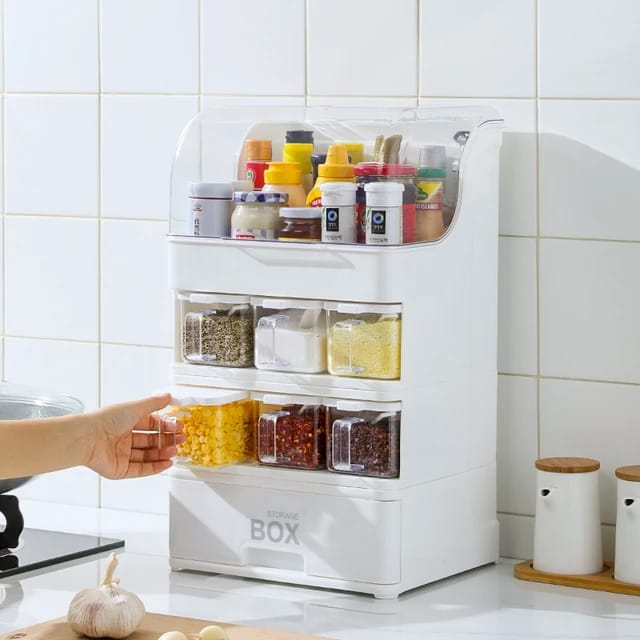 Someone taking a bottle from the Countertop Kitchen Storage Rack