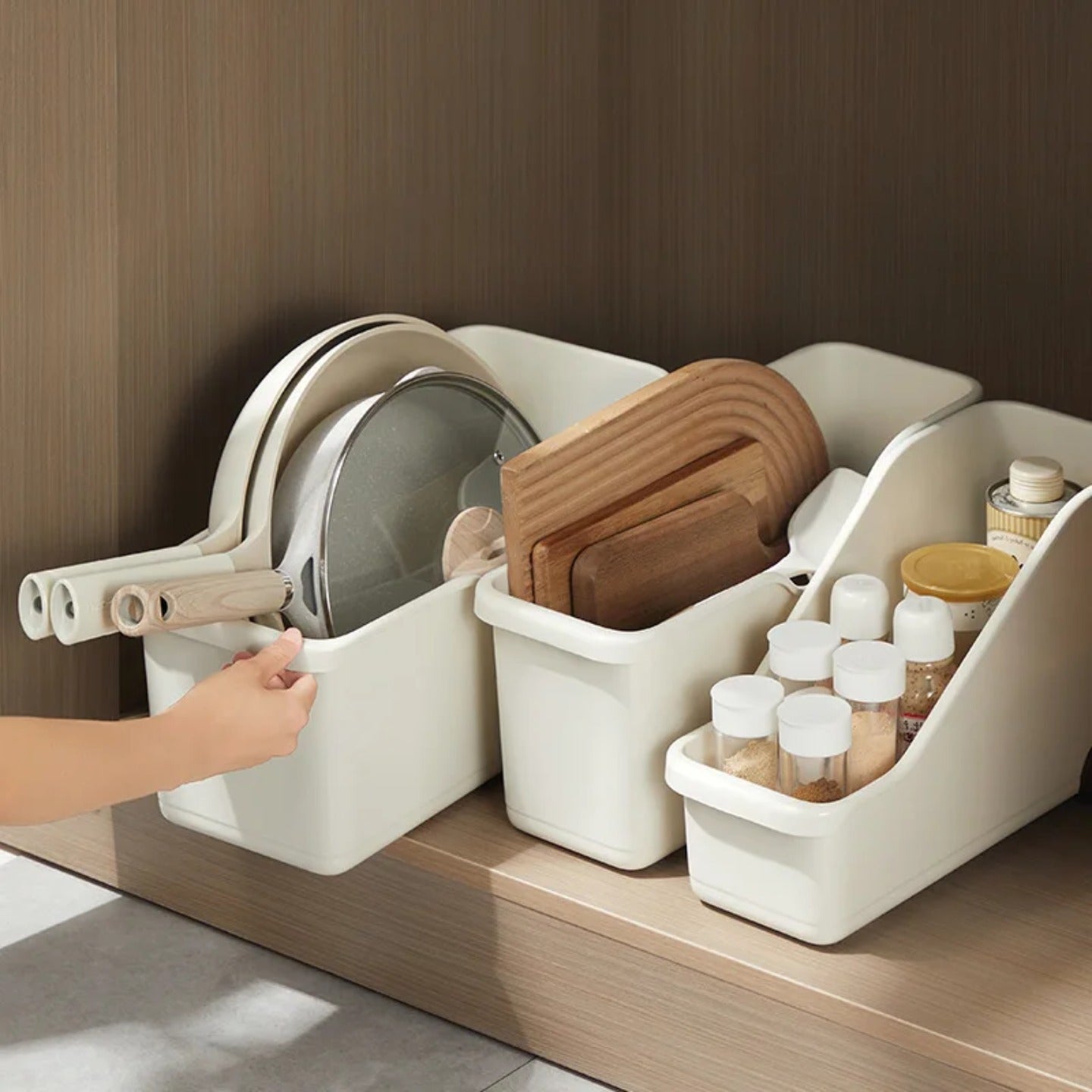 A Person is Pulling Cabinet Storage Organizer Box Which is Kept Inside a Cabinet Organized with Kitchen Essentials.