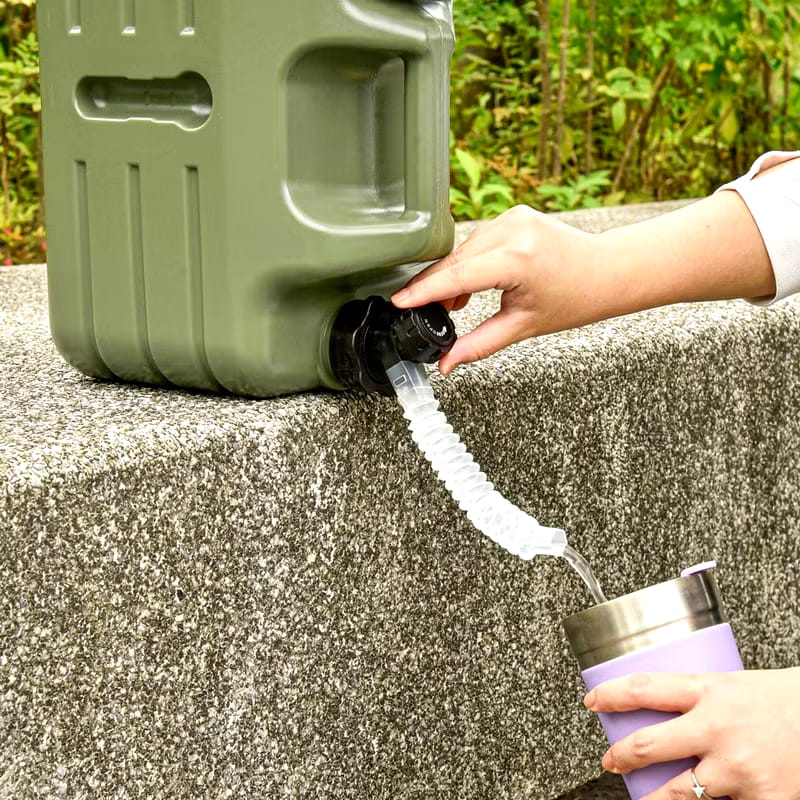 A Person is Taking Water From Camping Water Storage Container.