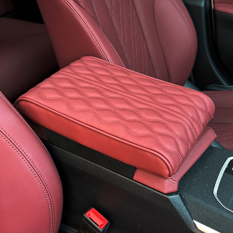 A Car Armrest Cushion is Placed on a Center Console of a Car.