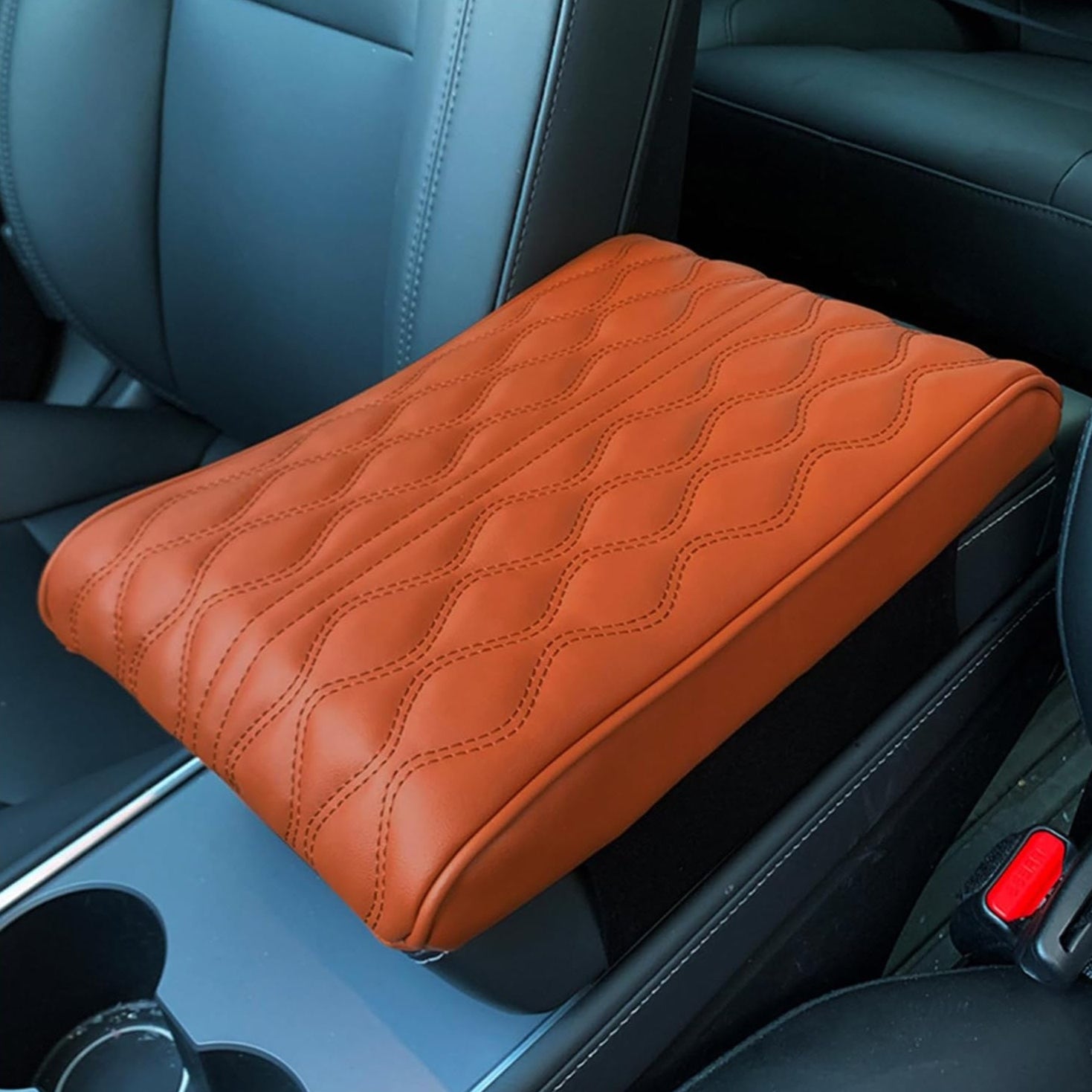 A Car Armrest Cushion is Placed on a Center Console of a Car.