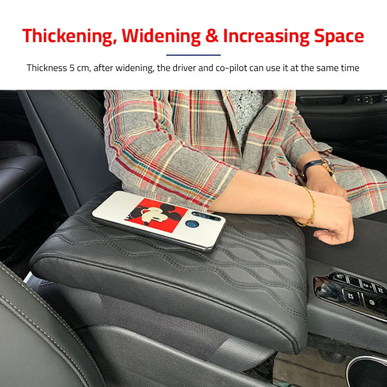 A Person is Placing his Elbow at Car Armrest Cushion Which is Placed on a Center Console of a Car.