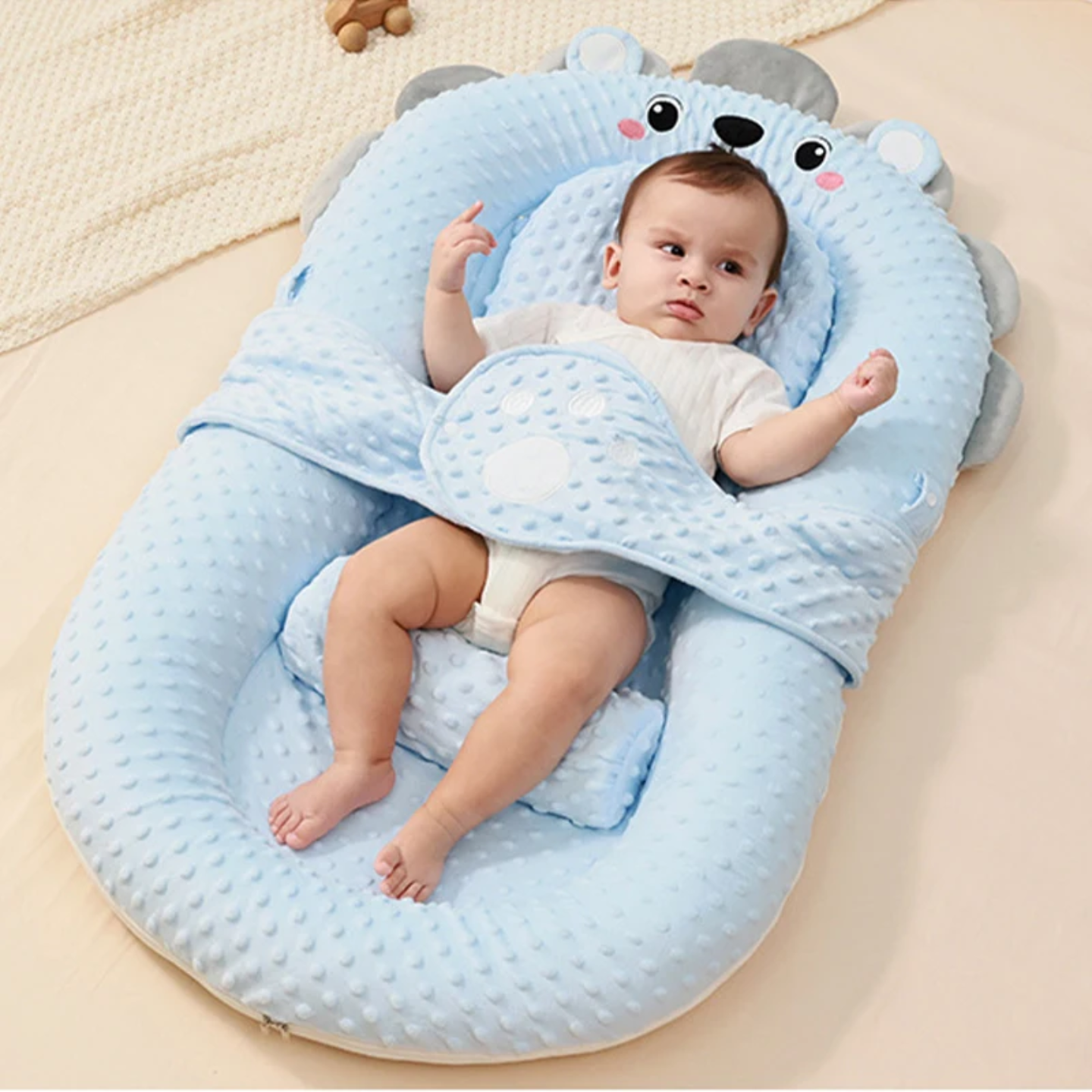 A Baby is lying down on the Comfortable Baby Nest Bed.