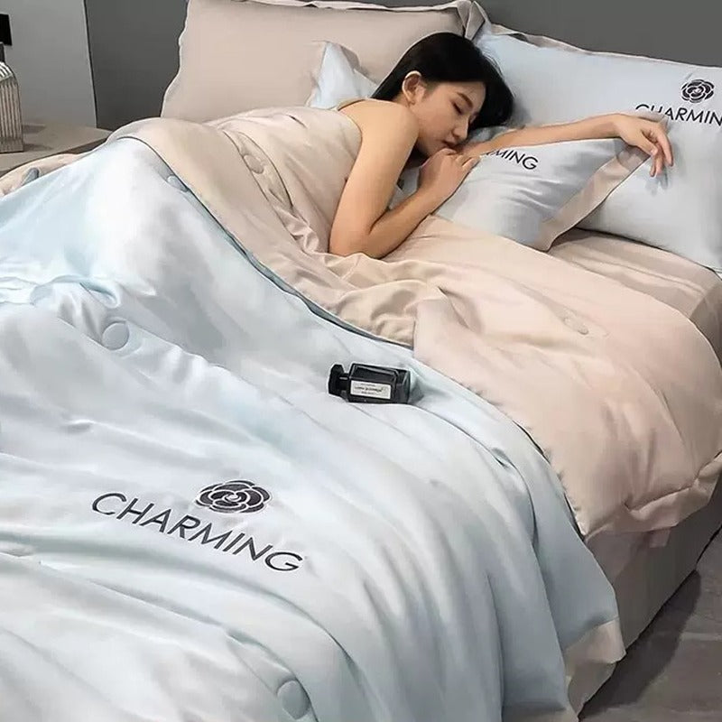 A Woman is Sleeping on Summer Quilted Cooling Comforter Bedding Set.
