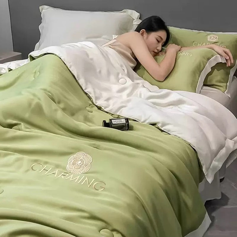 A Woman is Sleeping on Summer Quilted Cooling Comforter Bedding Set.