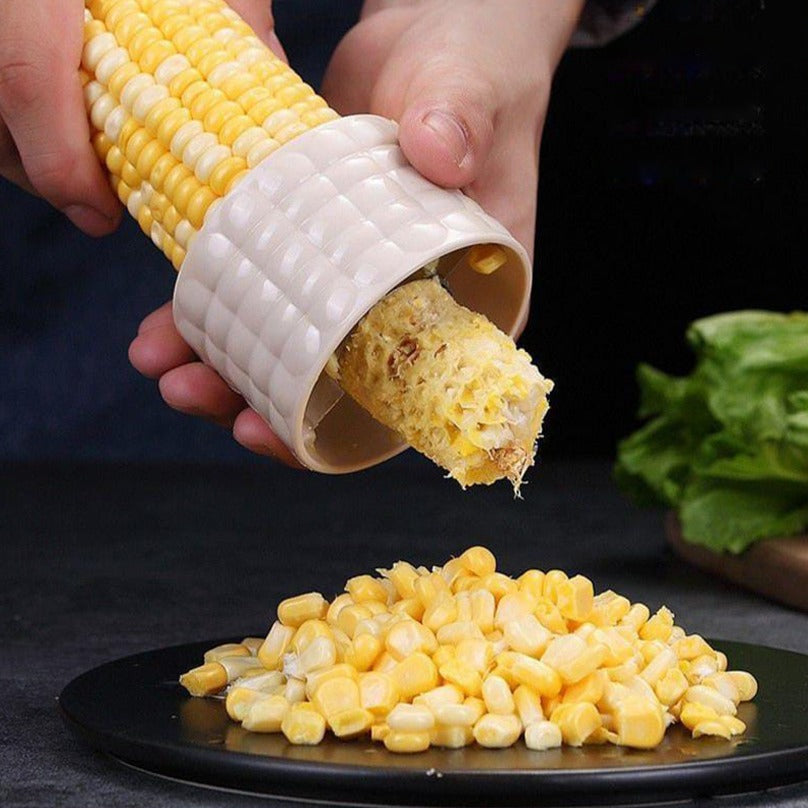 A Person Peeling Corn Using Corn Stripper Peeler.