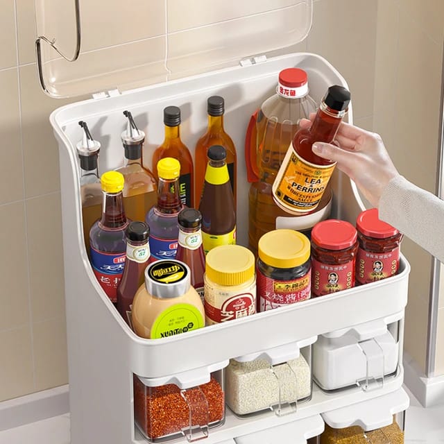 Someone taking a bottle from the Countertop Kitchen Storage Rack