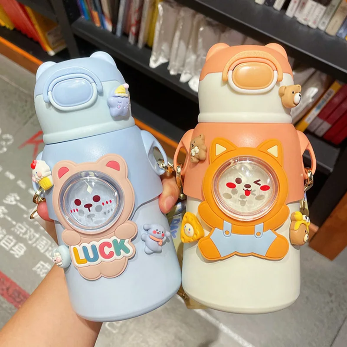 A Person is Holding Cute Cartoon Bear Water Bottles for Kids.