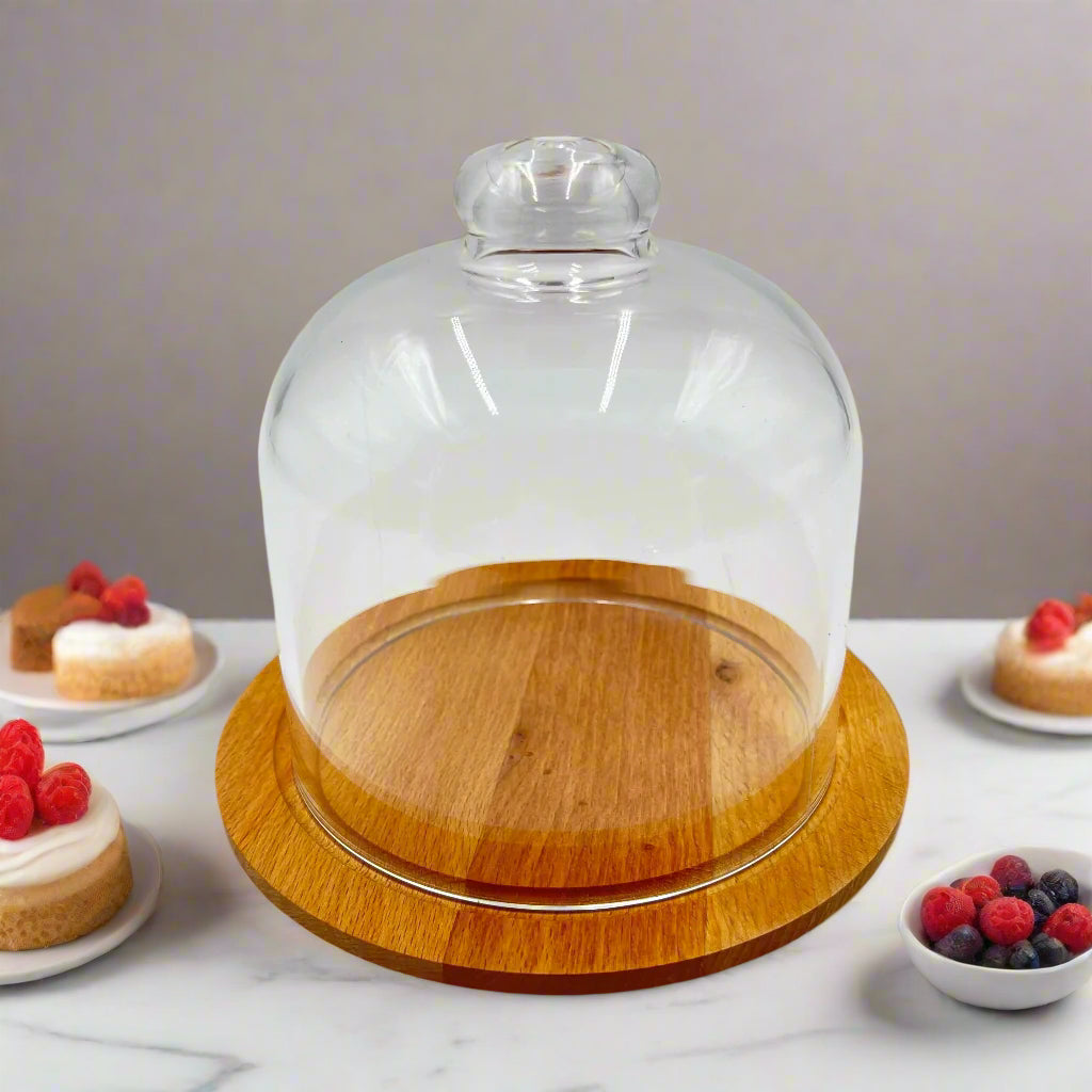 A Desert Dome with Wooden Base is Placed Between Cakes and Desserts.