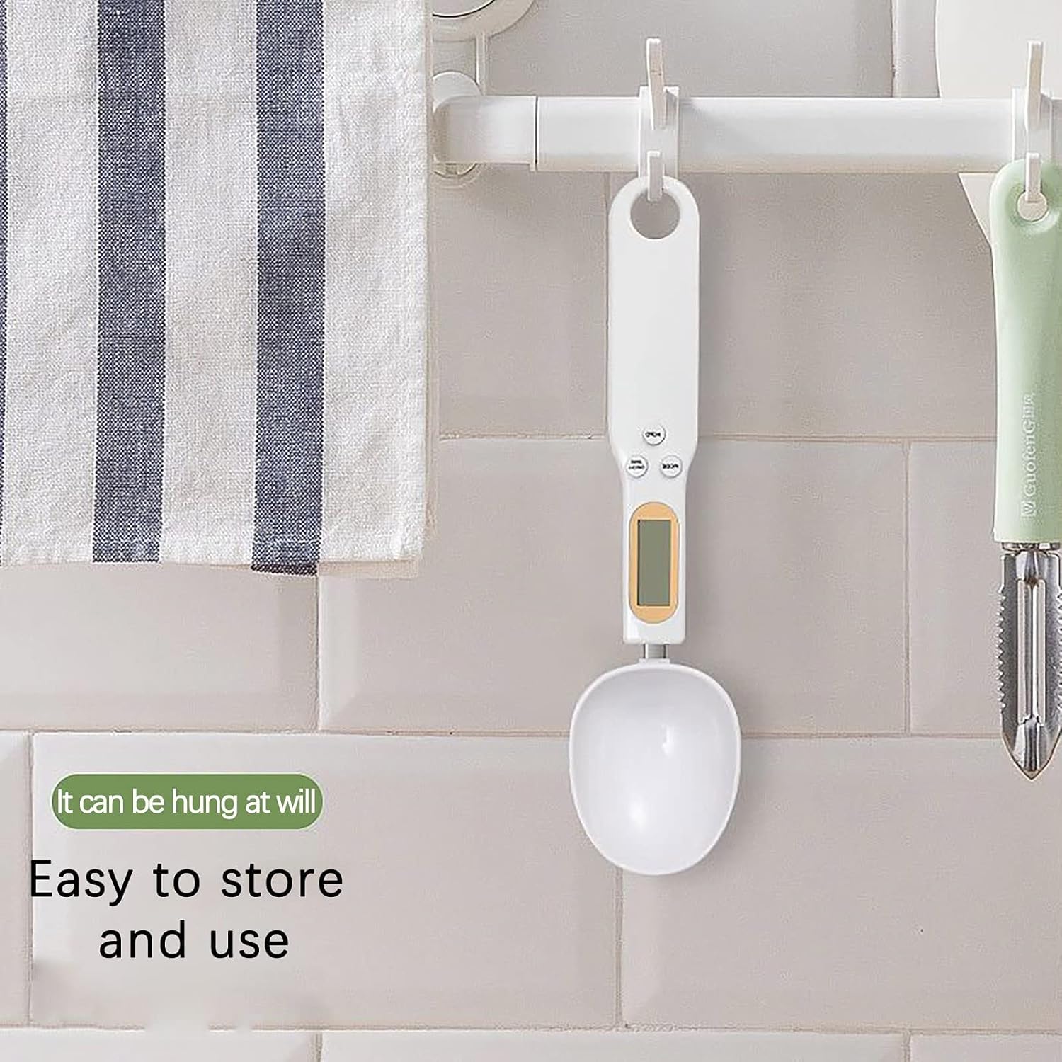 A Digital Spoon Scale is hanged on a rack located at kitchen.