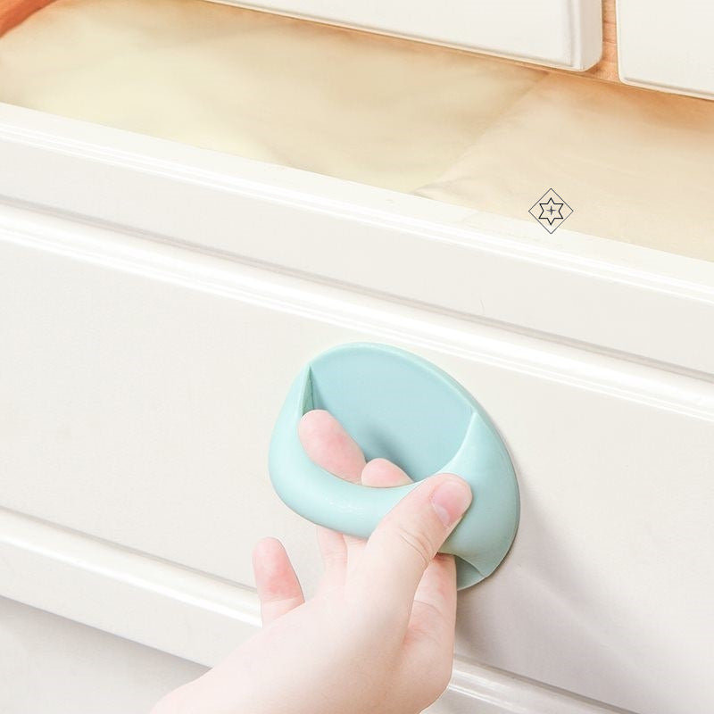 A Person is Opening a Wardrobe Using  Multi-functional Door Handle Sticked On it.