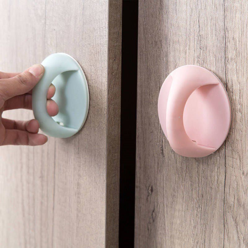 A Person is Opening a Door Using Handle In Blue and Pink Color.