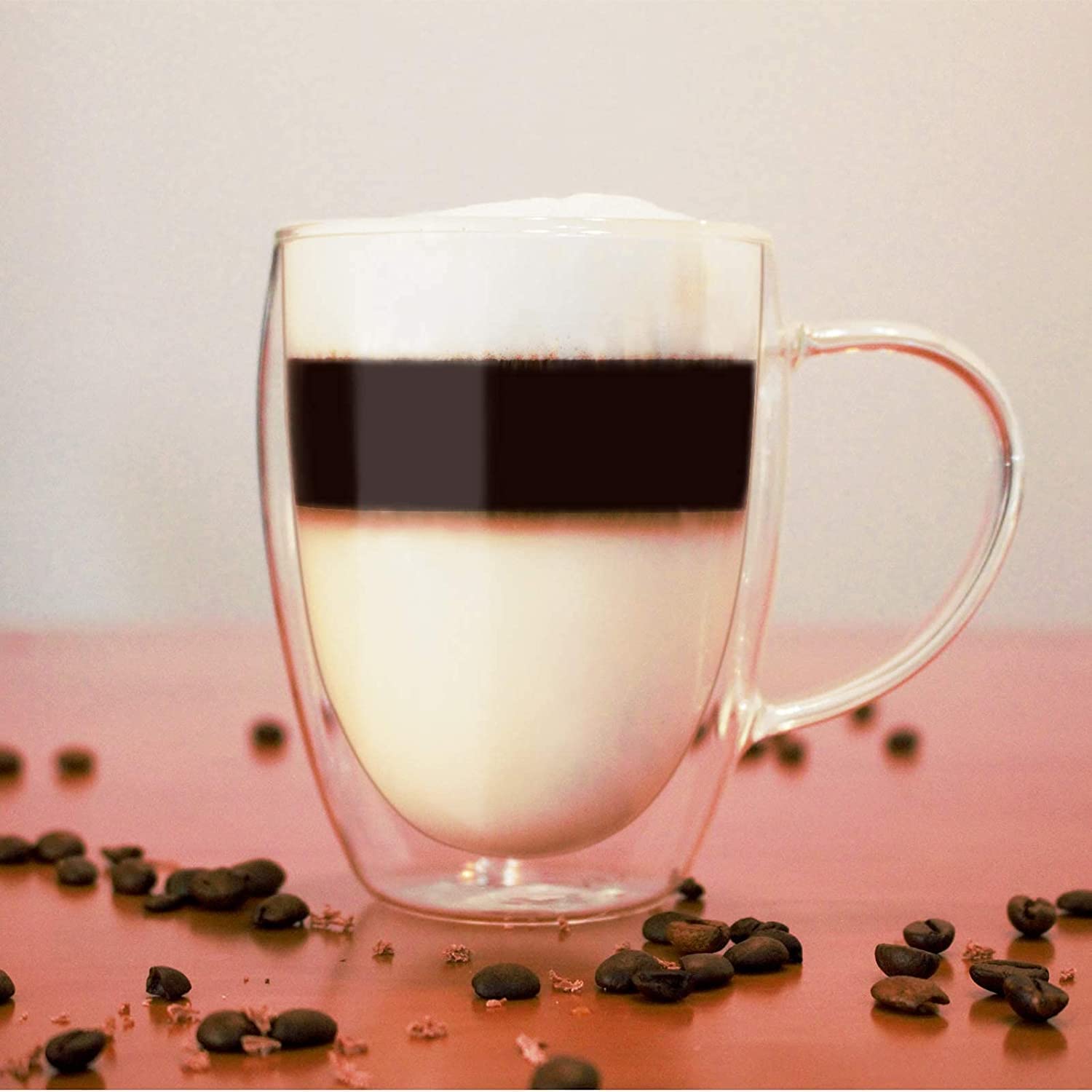 A Double Wall Glass Coffee Mug with Coffee in it.