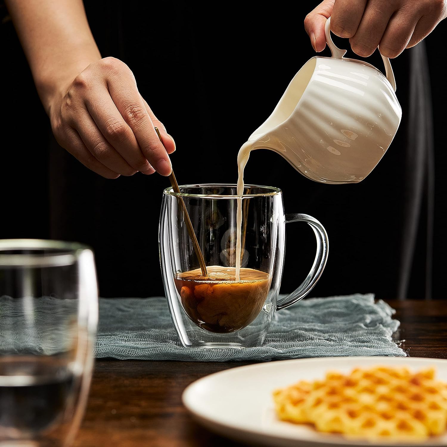 A Person is Pouring Coffee on to Double Wall Glass Coffee Mug.
