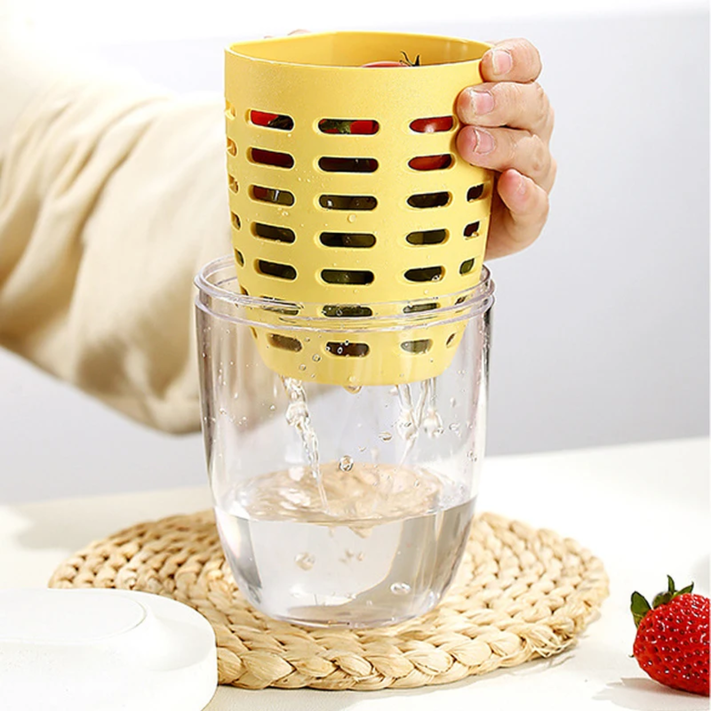 A Person is Draining Fruits in a Drainable Fruit Storage Cup.