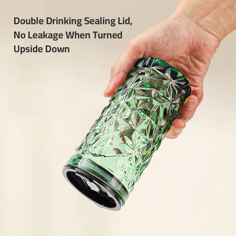 A Person is Holding Drinking Glass Tumbler With Straw and Lid.