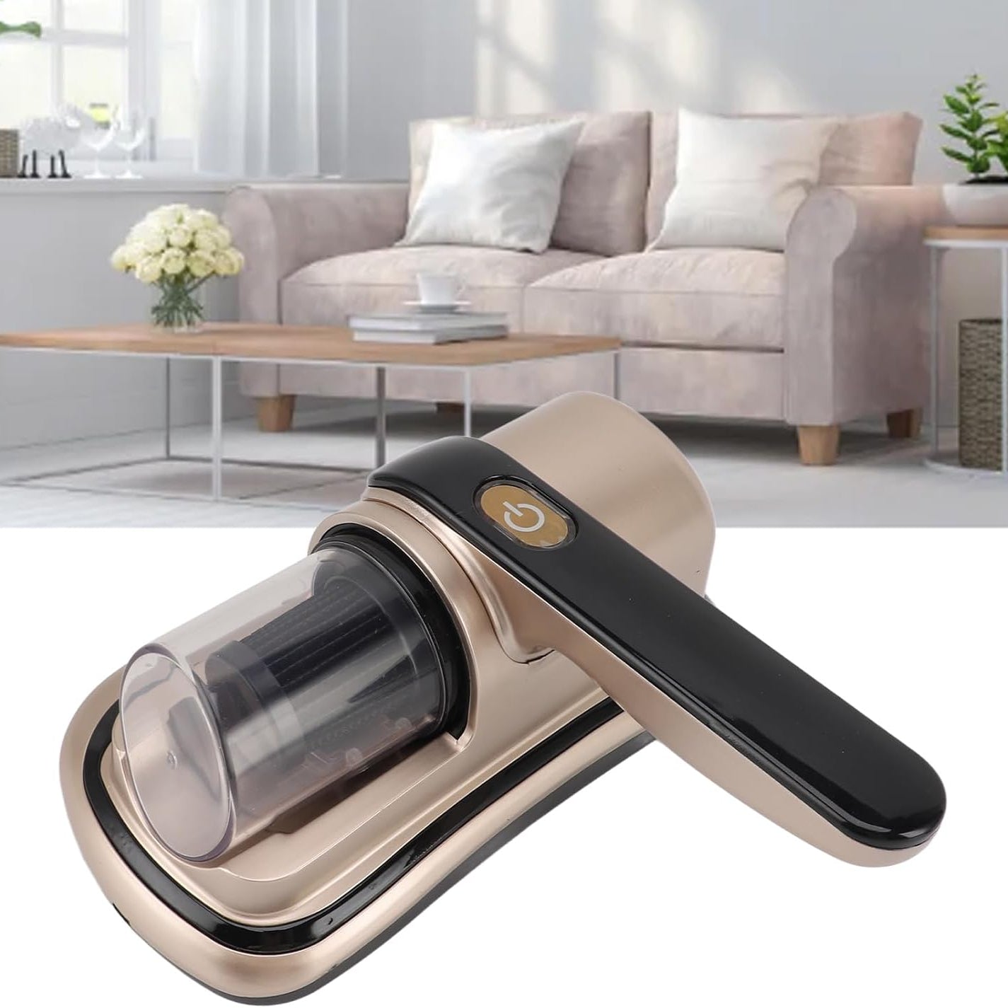 Wireless Dust Mite Removal Vacuum Cleaner with a metallic champagne-gold body, black handle, and clear dust container, shown in front of a blurred living room background with a sofa and coffee table.