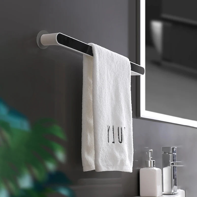 A towel is organized on the Towel Organizer Hanger in black color